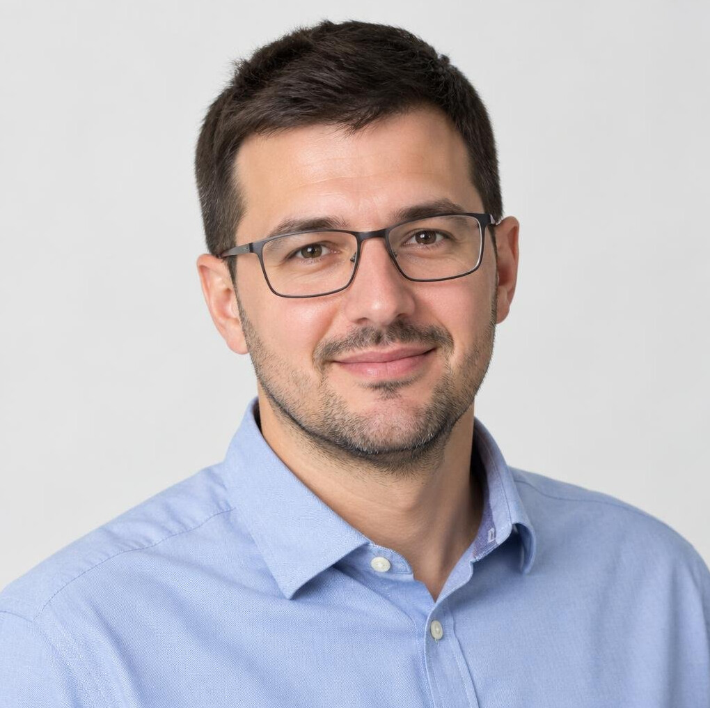 Studio portrait of a Croatian man with short hair and glasses