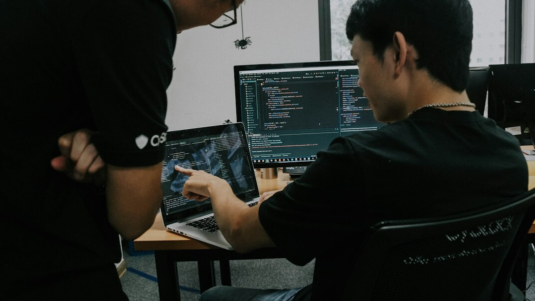 corporate programmers discussing code
