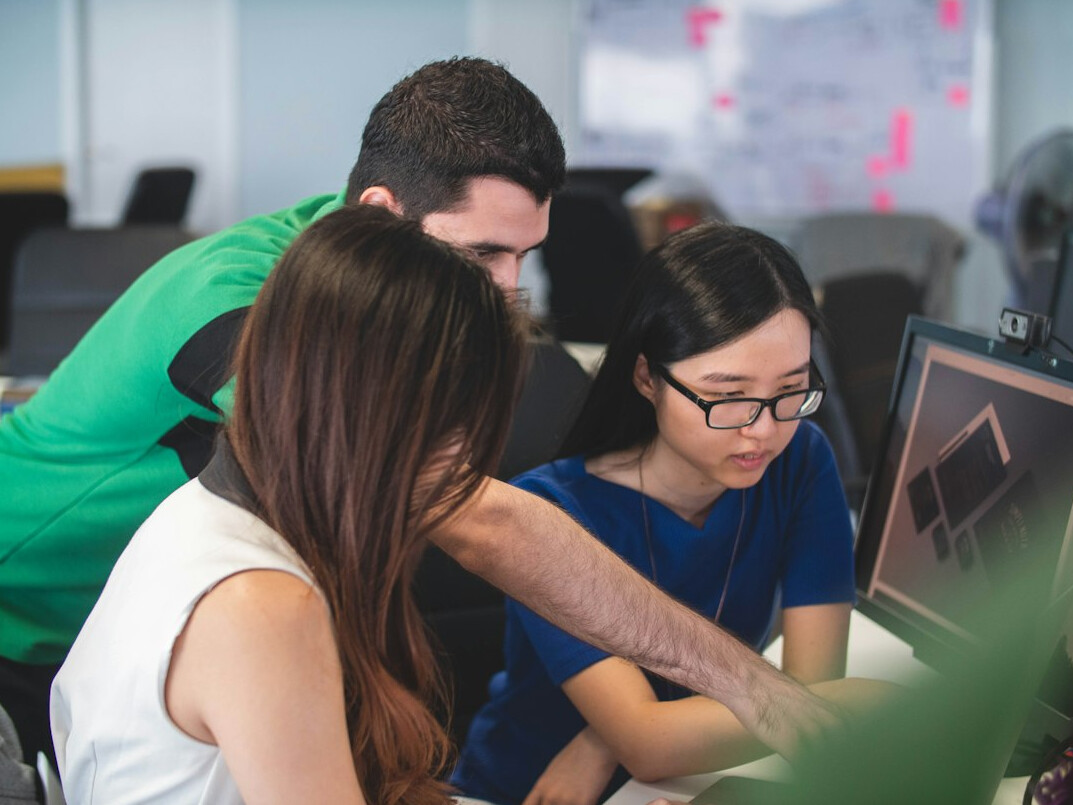 corporate team discussing code